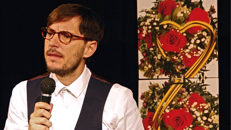 El actor principal de la obra hablando con un micrófono